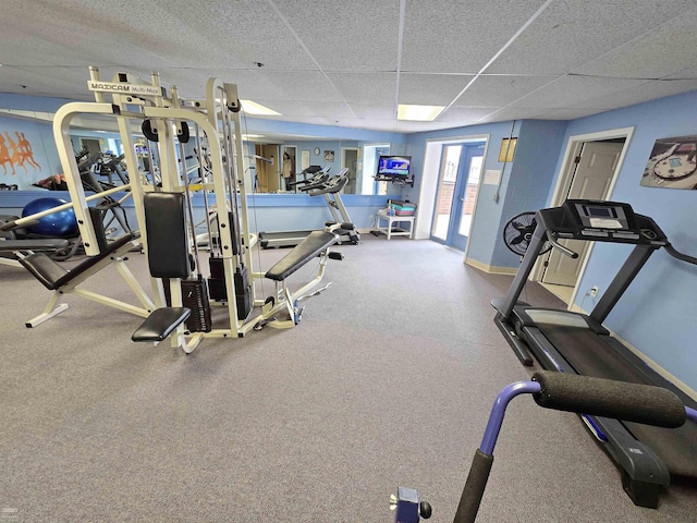 workout area featuring french doors and a drop ceiling