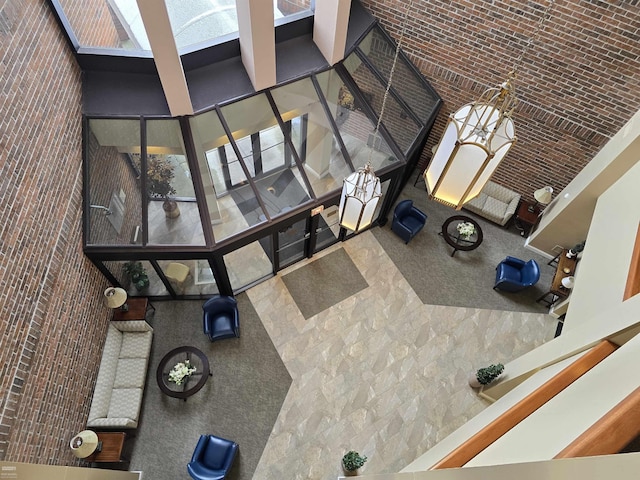 living room with brick ceiling and a towering ceiling