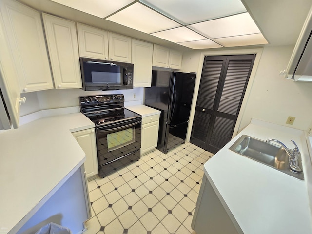 kitchen with sink, white cabinetry, and black appliances