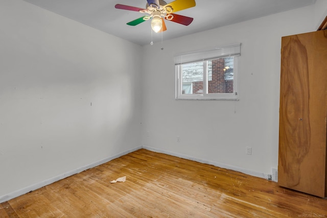 spare room with ceiling fan and wood-type flooring