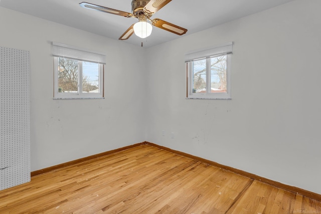 unfurnished room with ceiling fan and light wood-type flooring