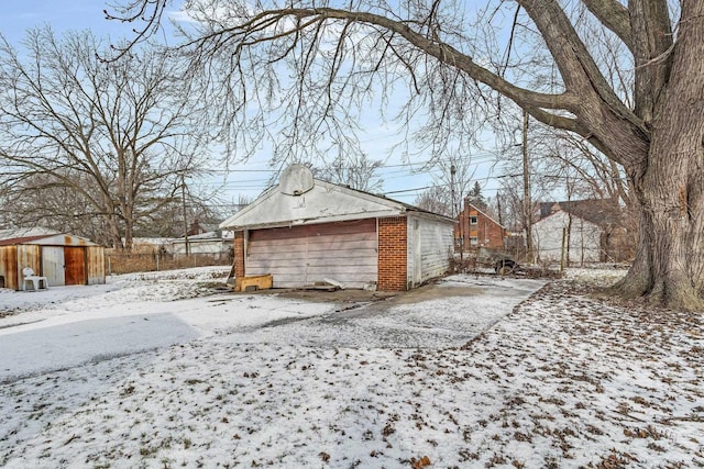 snowy yard with a storage unit