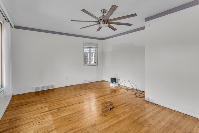 spare room featuring ceiling fan, crown molding, and light hardwood / wood-style floors