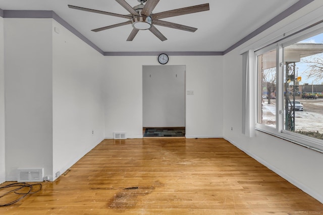 unfurnished room featuring ceiling fan, ornamental molding, and light wood-type flooring