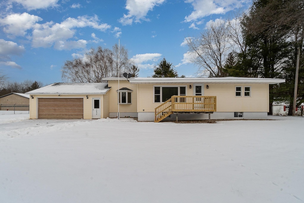 view of front of home with a garage and a deck