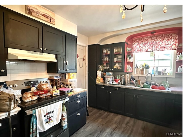 kitchen with dark hardwood / wood-style flooring, decorative backsplash, sink, hanging light fixtures, and stainless steel electric range