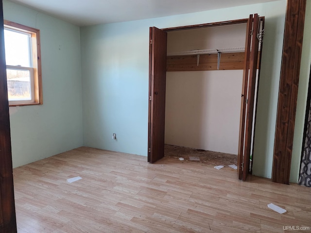 unfurnished bedroom with light wood-type flooring