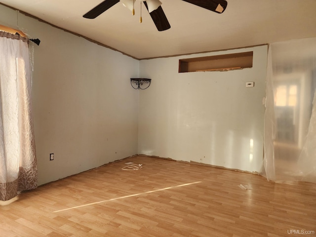 empty room with ceiling fan and hardwood / wood-style floors