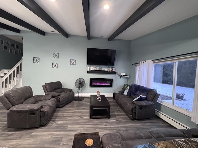 living area with wood finished floors, baseboards, a baseboard radiator, a glass covered fireplace, and beamed ceiling