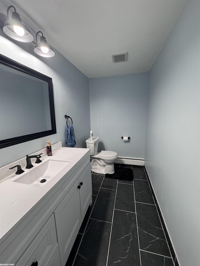 half bath featuring visible vents, toilet, a baseboard heating unit, baseboards, and vanity