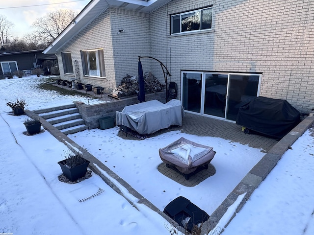 exterior space featuring grilling area and an outdoor fire pit