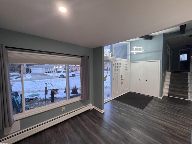 entryway with baseboards, stairs, a baseboard heating unit, and dark wood-type flooring