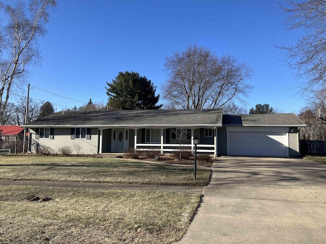 ranch-style home with a garage and a front lawn