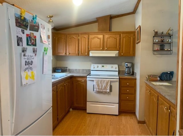 kitchen featuring white appliances, light wood-type flooring, ornamental molding, and vaulted ceiling