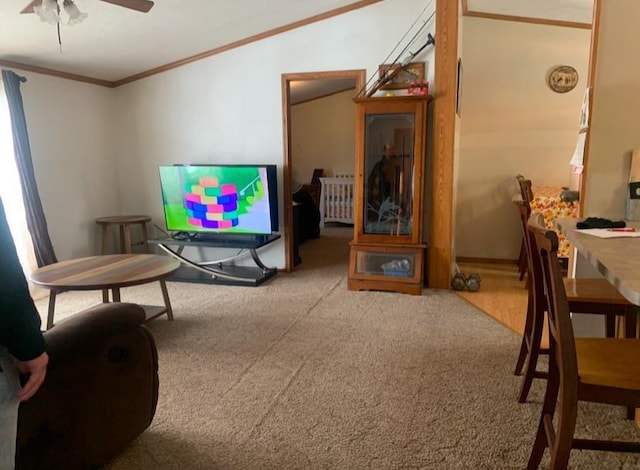 living room with carpet, radiator, ceiling fan, and ornamental molding