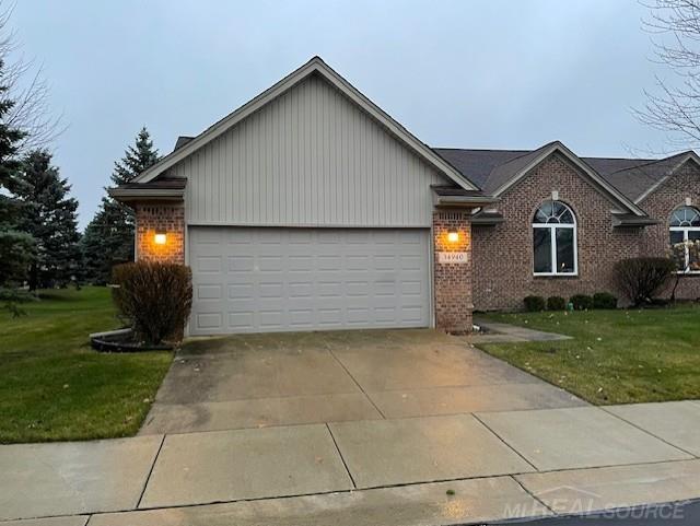 view of front of property featuring a front yard and a garage