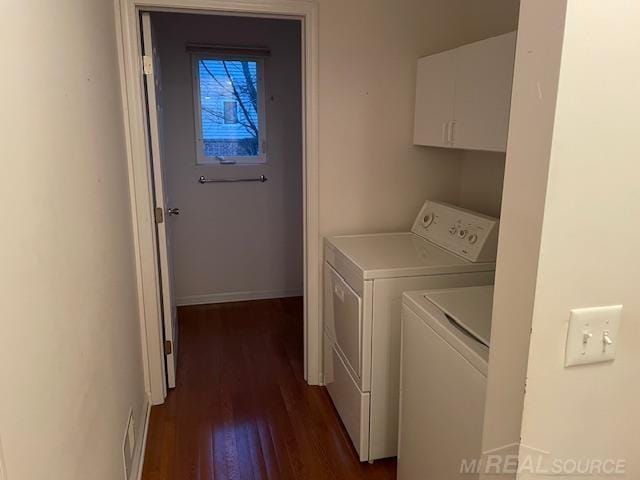 laundry room featuring washing machine and clothes dryer and dark hardwood / wood-style flooring