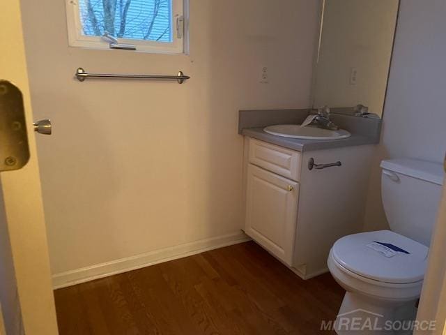 bathroom featuring hardwood / wood-style floors, toilet, and vanity