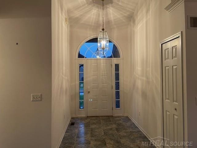 foyer entrance featuring an inviting chandelier