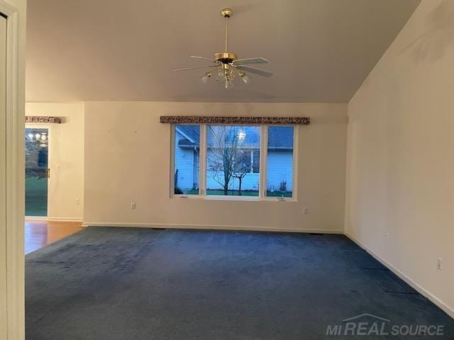 carpeted empty room with lofted ceiling and ceiling fan