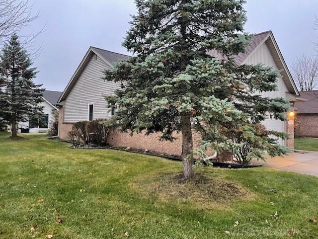 view of side of home featuring a yard