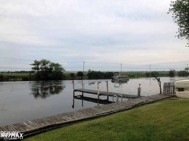 view of dock featuring a water view and a yard