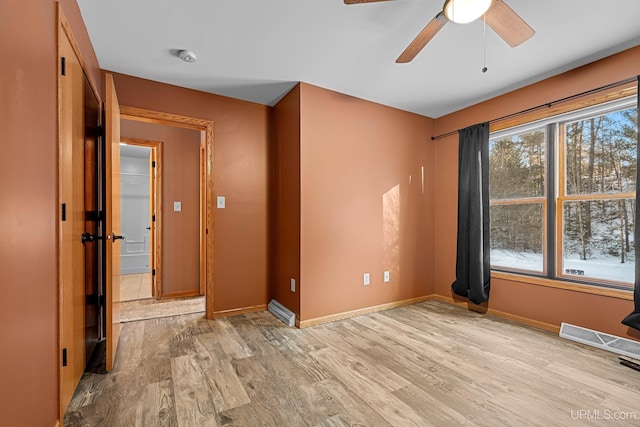 empty room with light wood-type flooring and ceiling fan