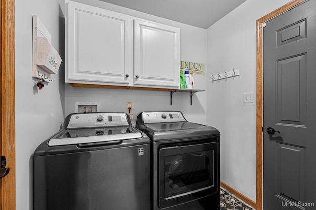 clothes washing area featuring cabinets and washing machine and dryer