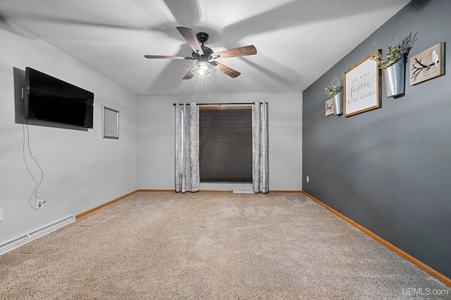 spare room with ceiling fan and carpet