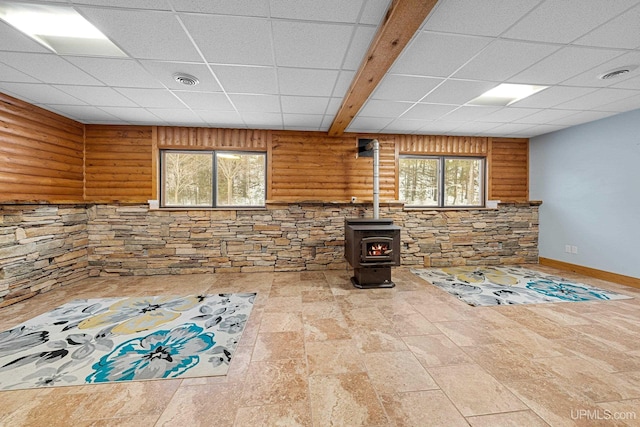 interior space with a wood stove and a wealth of natural light