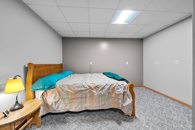 bedroom featuring a paneled ceiling and carpet flooring