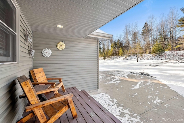 view of snow covered back of property