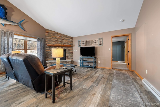 living room with vaulted ceiling, hardwood / wood-style floors, and baseboard heating