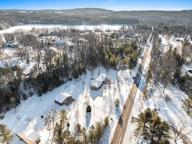 snowy aerial view with a mountain view