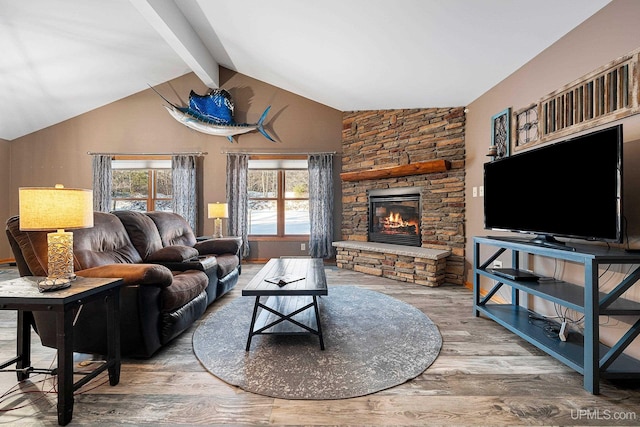 living room featuring hardwood / wood-style floors, a fireplace, and lofted ceiling with beams