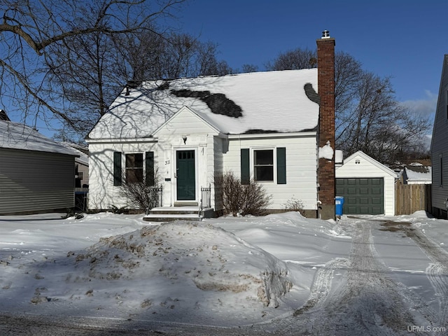 view of front facade with a garage and an outbuilding