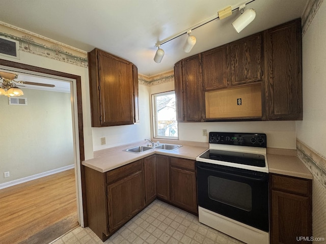 kitchen featuring sink, dark brown cabinets, electric range, and ceiling fan