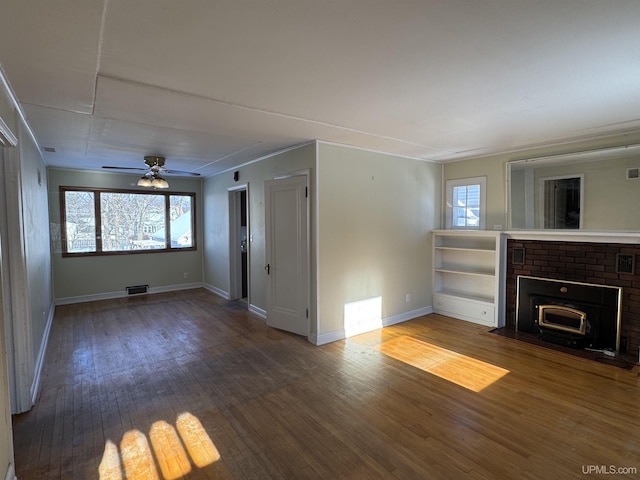 unfurnished living room featuring a fireplace, hardwood / wood-style floors, plenty of natural light, and ceiling fan