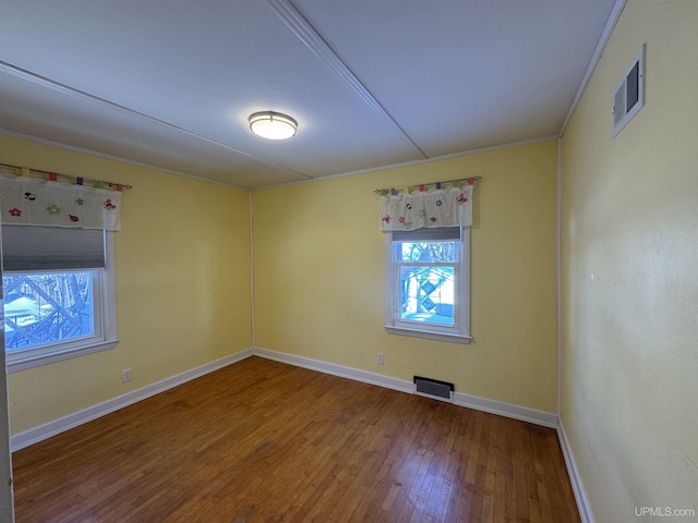 unfurnished room with wood-type flooring