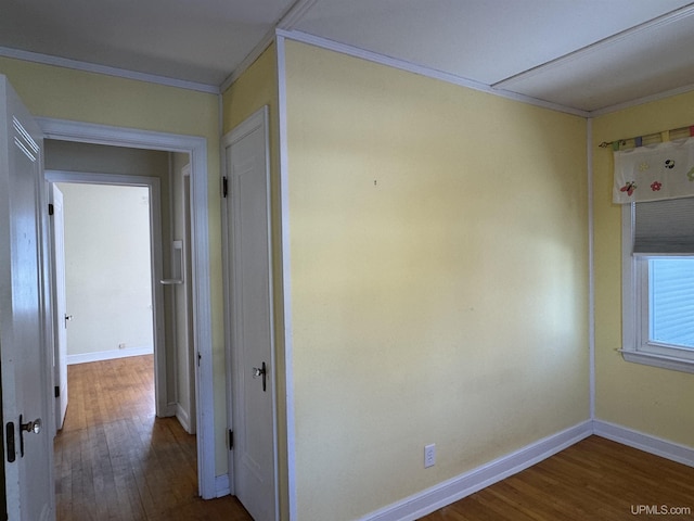 hallway with crown molding and hardwood / wood-style floors