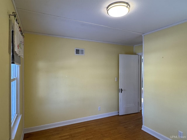 spare room with hardwood / wood-style flooring and ornamental molding