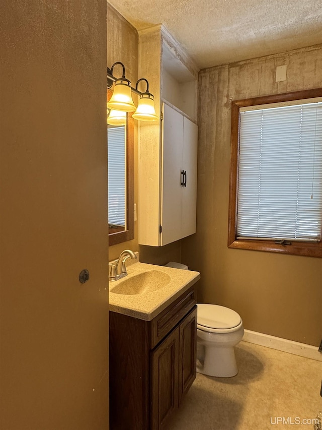 bathroom with toilet, a textured ceiling, and vanity