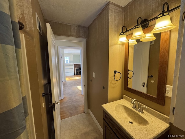 bathroom with vanity and a textured ceiling