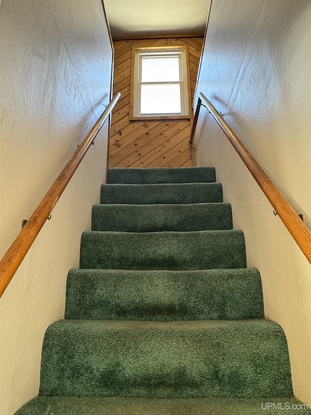 staircase with wooden walls