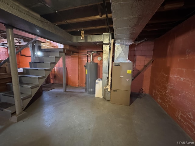 basement featuring water heater and heating unit