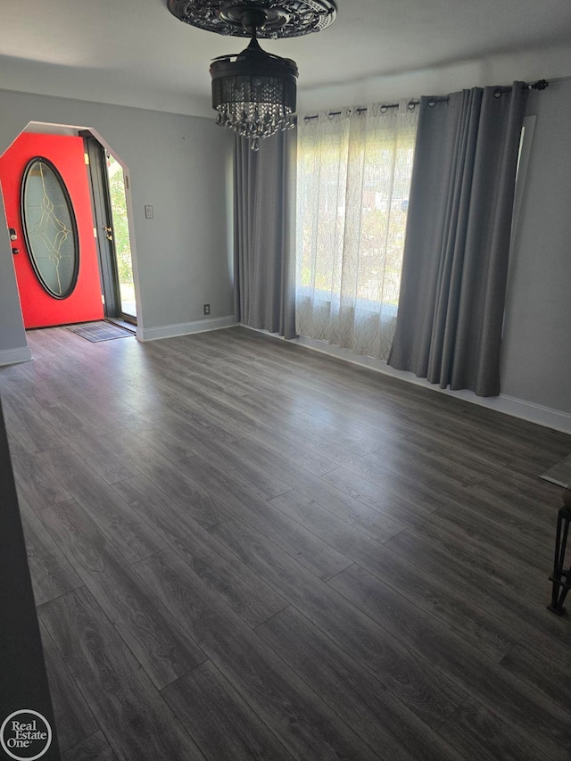 foyer with dark hardwood / wood-style floors and a notable chandelier