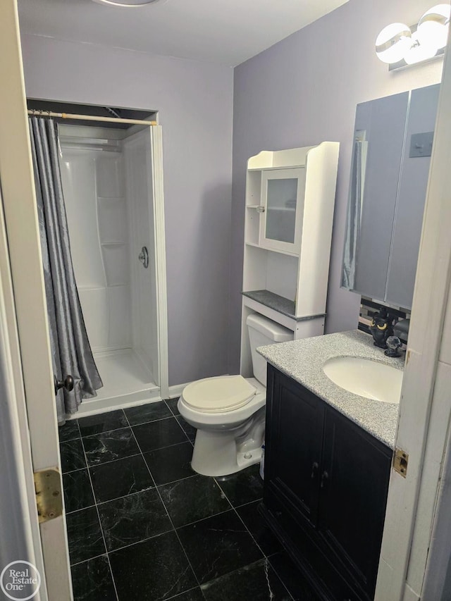 bathroom featuring vanity, toilet, and walk in shower