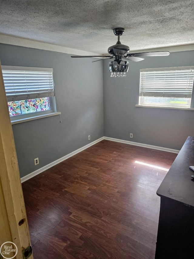 unfurnished room featuring a textured ceiling, ceiling fan, and dark hardwood / wood-style flooring