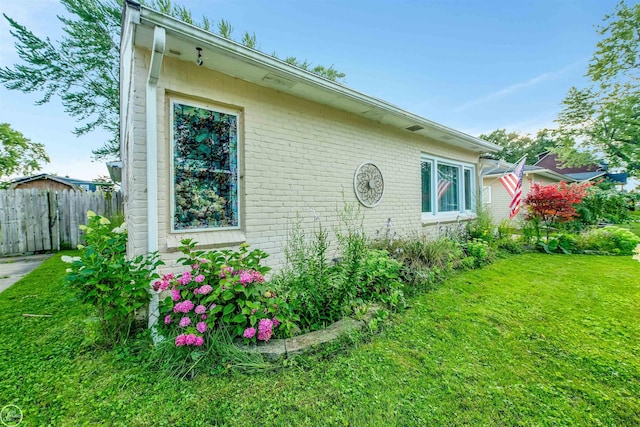 view of property exterior with a yard