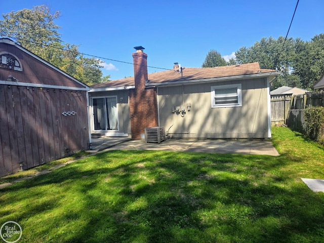 rear view of house with a patio area and a lawn